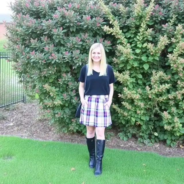 Playful grunge lavender plaid skirt paired with a black top for an edgy and stylish look.